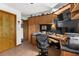 Bright office offers custom built-ins and wood tile flooring; perfect work-from-home space at 5035 Harbinger Rd, Spring Hill, FL 34608
