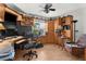 Spacious office features custom built-in cabinets, wood floors, ceiling fan, and a large window with natural light at 5035 Harbinger Rd, Spring Hill, FL 34608