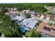 Aerial view of a neighborhood featuring beautiful homes, mature trees, and serene views at 5249 Wellfield Rd, New Port Richey, FL 34655