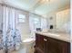 Bright bathroom features a bathtub, toilet, and a dark wood vanity with a granite countertop at 5249 Wellfield Rd, New Port Richey, FL 34655