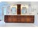 Elegant bathroom with double vanities, marble countertops, and decorative mirrors at 5249 Wellfield Rd, New Port Richey, FL 34655