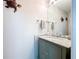 Bathroom features a stylish vanity with granite countertop, and decorative wall art for added charm at 5249 Wellfield Rd, New Port Richey, FL 34655
