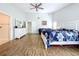 Open bedroom with vaulted ceilings, wood-look tile floors, and access to the Primary bath and closet at 5249 Wellfield Rd, New Port Richey, FL 34655