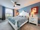 Bright bedroom features a white-painted bed frame, complementing the side tables and a large window at 5249 Wellfield Rd, New Port Richey, FL 34655