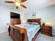 Bedroom with a TV on a wood dresser, featuring a sleigh bed, lamps, and matching end tables at 5249 Wellfield Rd, New Port Richey, FL 34655