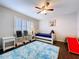 Charming bedroom with a ceiling fan, natural light and playful decor for a cheerful and inviting space at 5249 Wellfield Rd, New Port Richey, FL 34655