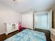 Bedroom with wood floors, a blue rug, a closet, and bright natural light to create a welcoming space at 5249 Wellfield Rd, New Port Richey, FL 34655