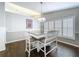 Dining area boasts stylish chandelier lighting and views of the yard through shuttered windows at 5249 Wellfield Rd, New Port Richey, FL 34655