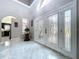 Grand foyer with gleaming tile, high ceilings, and beautiful glass front doors creates a stunning entrance at 5249 Wellfield Rd, New Port Richey, FL 34655