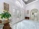 Bright foyer with marble floors, high ceilings, and decorative glass front doors welcomes you into the home at 5249 Wellfield Rd, New Port Richey, FL 34655