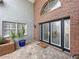 Inviting front entrance features a beautiful brick facade, elegant double doors, and a well-maintained walkway at 5249 Wellfield Rd, New Port Richey, FL 34655