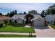Lovely single-Gathering home featuring mature landscaping, arched windows, and a two-car garage at 5249 Wellfield Rd, New Port Richey, FL 34655