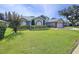 Attractive single-story home featuring mature landscaping, arched windows, and a two-car garage at 5249 Wellfield Rd, New Port Richey, FL 34655