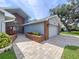 Well-manicured front yard with walkway to the two car garage, with attractive curb appeal at 5249 Wellfield Rd, New Port Richey, FL 34655