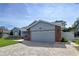 Two-car garage with brick accents and manicured landscaping, with charming curb appeal at 5249 Wellfield Rd, New Port Richey, FL 34655