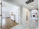 Hallway with tile and wood floors that leads to the living room, bathroom, and other rooms at 5249 Wellfield Rd, New Port Richey, FL 34655