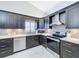Well-equipped kitchen boasts stainless steel appliances, tile flooring, ample cabinet space, and updated countertops at 5249 Wellfield Rd, New Port Richey, FL 34655