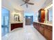 Spacious bathroom with dual sinks, cherry wood cabinetry, and a luxury walk-in shower at 5249 Wellfield Rd, New Port Richey, FL 34655