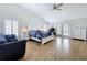 Spacious primary bedroom has vaulted ceilings, wood floors, a ceiling fan, plantation shutters and French doors at 5249 Wellfield Rd, New Port Richey, FL 34655