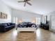 Spacious main bedroom with vaulted ceiling, ceiling fan, wood-look floors, and abundant natural light from windows at 5249 Wellfield Rd, New Port Richey, FL 34655