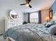 Main bedroom featuring a large window, white dresser, blue accents and lots of natural light for a cozy atmosphere at 5249 Wellfield Rd, New Port Richey, FL 34655