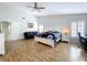 Well-lit main bedroom features wood-look floors, ceiling fan, and access to an attached bathroom at 5249 Wellfield Rd, New Port Richey, FL 34655