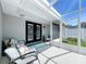 Covered patio with cozy seating, perfect for relaxing outdoors at 5249 Wellfield Rd, New Port Richey, FL 34655