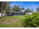 Wide shot of the backyard with a view of the rear exterior and lawn at 5323 23Rd St, Zephyrhills, FL 33542