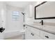 Bathroom features white cabinets, tiled walls, and modern fixtures at 5323 23Rd St, Zephyrhills, FL 33542