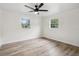 Spacious bedroom with wood-look flooring and natural light from two windows at 5323 23Rd St, Zephyrhills, FL 33542