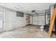 Spacious garage with shelving and door to the outside at 5323 23Rd St, Zephyrhills, FL 33542
