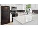Renovated kitchen with white cabinets, quartz countertops, and stainless steel appliances at 5323 23Rd St, Zephyrhills, FL 33542