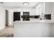 Bright kitchen features modern appliances, white cabinets, and dark tile backsplash at 5323 23Rd St, Zephyrhills, FL 33542