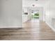Open living area with wood flooring, sliding glass doors, and freshly painted walls at 5323 23Rd St, Zephyrhills, FL 33542