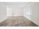 Bright, freshly painted living room featuring wood floors, with natural light streaming through large window at 5323 23Rd St, Zephyrhills, FL 33542