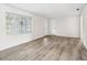 The bright living room has modern wood flooring, natural light, and a fresh, clean aesthetic at 5323 23Rd St, Zephyrhills, FL 33542
