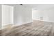 A bright, freshly painted living room featuring modern wood flooring and neutral color palette at 5323 23Rd St, Zephyrhills, FL 33542