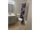 This bathroom features a vanity, toilet, tub and shower with a floral shower curtain at 5708 Townhouse Dr # 5708, New Port Richey, FL 34652