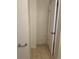 A view of the bathroom featuring neutral tile flooring and paint color with a white door at 5708 Townhouse Dr # 5708, New Port Richey, FL 34652