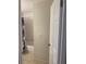 A view into the bathroom featuring white tile and neutral colored walls and a floral shower curtain at 5708 Townhouse Dr # 5708, New Port Richey, FL 34652