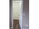 View into a closet featuring wood-look flooring and white walls with an open white door at 5708 Townhouse Dr # 5708, New Port Richey, FL 34652