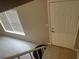 Welcoming entryway featuring a bright window and a classic white door, complemented by neutral tile flooring at 5708 Townhouse Dr # 5708, New Port Richey, FL 34652