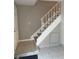 Welcoming entryway features a staircase with decorative railings, tiled floors, and ample natural light at 5708 Townhouse Dr # 5708, New Port Richey, FL 34652