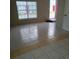 Spacious living room featuring tile flooring, a large window for natural light, and neutral wall colors at 5708 Townhouse Dr # 5708, New Port Richey, FL 34652