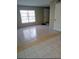 Inviting living room with bright natural light from the large window, and neutral wall colors at 5708 Townhouse Dr # 5708, New Port Richey, FL 34652