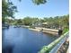 Scenic waterfront featuring calm waters, boat docks, lush greenery, and a gazebo at 5708 Townhouse Dr # 5708, New Port Richey, FL 34652