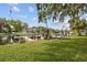 Waterfront backyard with a private dock, boat lift, and lush green lawn offering a serene outdoor space at 6046 River Rd, New Port Richey, FL 34652