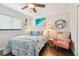 Charming bedroom with hardwood floors, a comfortable chair, and coastal-themed decor creating a relaxing retreat at 6046 River Rd, New Port Richey, FL 34652