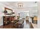 Dining room with a wooden table, bench seating, stylish decor, and seamless flow into the living room at 6046 River Rd, New Port Richey, FL 34652