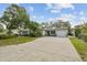 Charming single-story home featuring a long driveway, well-maintained landscaping, and an attached one-car garage at 6046 River Rd, New Port Richey, FL 34652